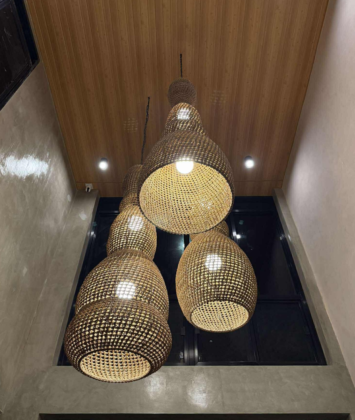 Artisan installing rattan pendants
