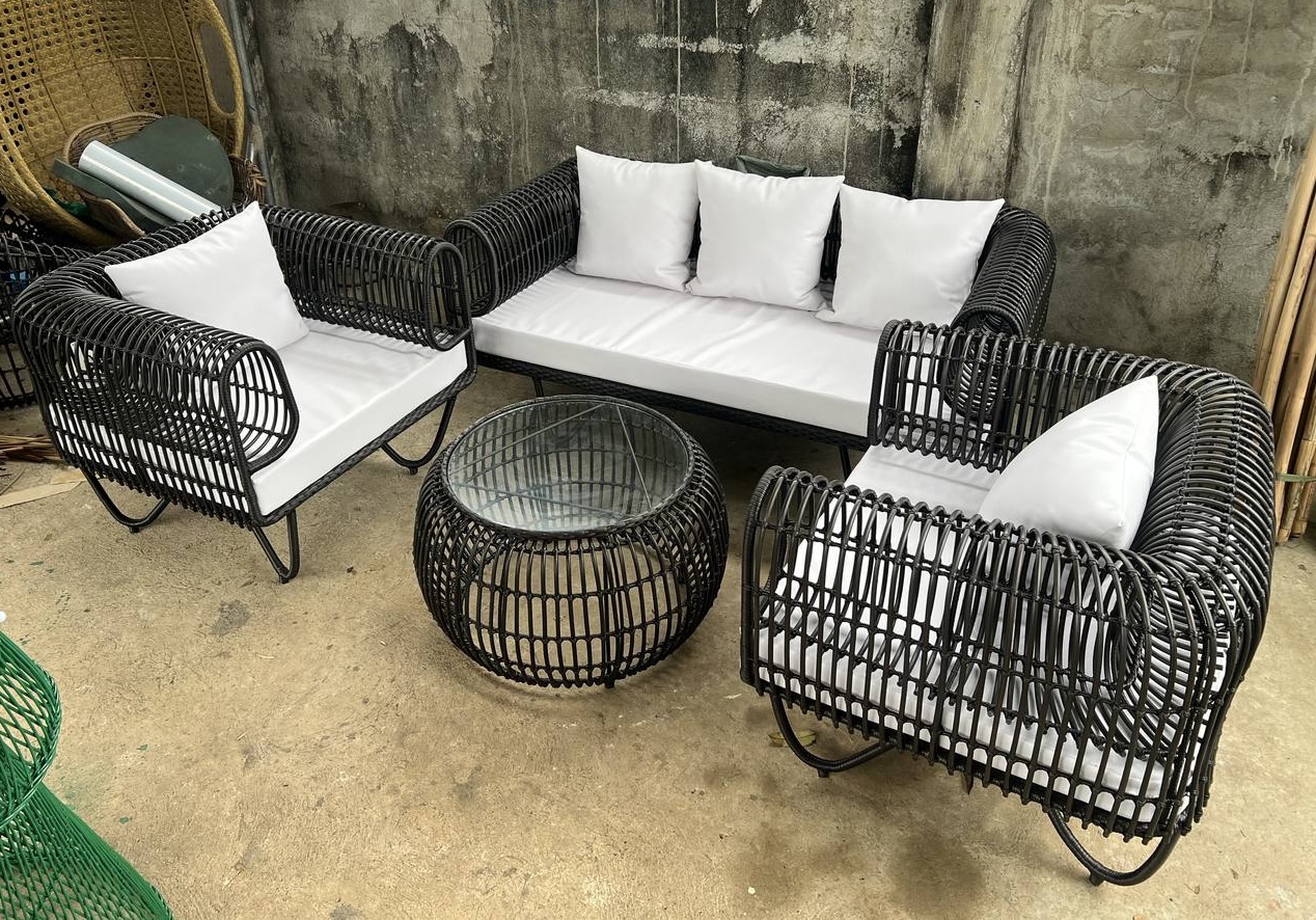 Black rattan sofa white cushions